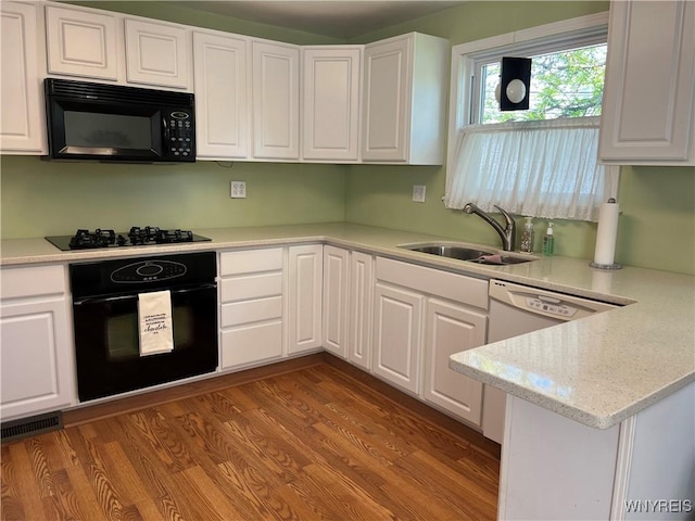 118 Erie St, Lancaster, NY 14086 - kitchen with black appliances, a sink, white cabinetry, light countertops, and dark wood-style floors