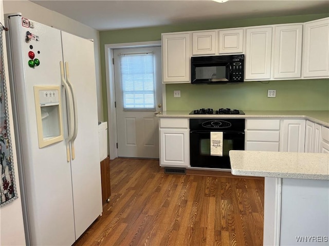 118 Erie St, Lancaster, NY 14086 - kitchen featuring black appliances, white cabinetry, dark wood-style floors, and light stone countertops