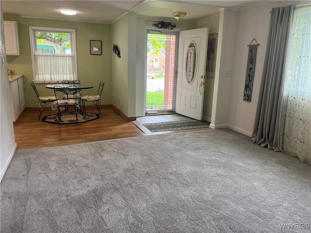 118 Erie St, Lancaster, NY 14086 - foyer with carpet flooring, healthy amount of natural light, baseboards, crown molding, and wood finished floors