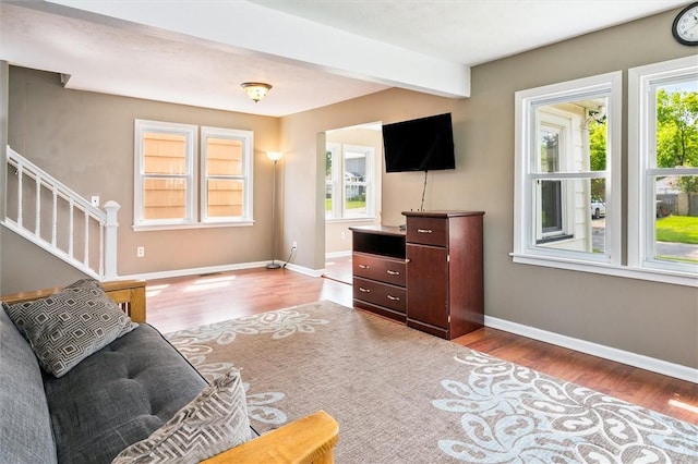 86 Leonard Rd, Greece, NY 14616 - living room with wood finished floors, baseboards, stairs, and beamed ceiling