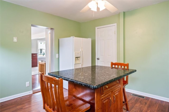86 Leonard Rd, Greece, NY 14616 - kitchen featuring a kitchen bar, dark wood-type flooring, baseboards, and a ceiling fan