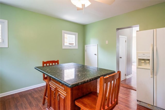 86 Leonard Rd, Greece, NY 14616 - kitchen with white fridge with ice dispenser, a breakfast bar, dark wood-type flooring, and a ceiling fan