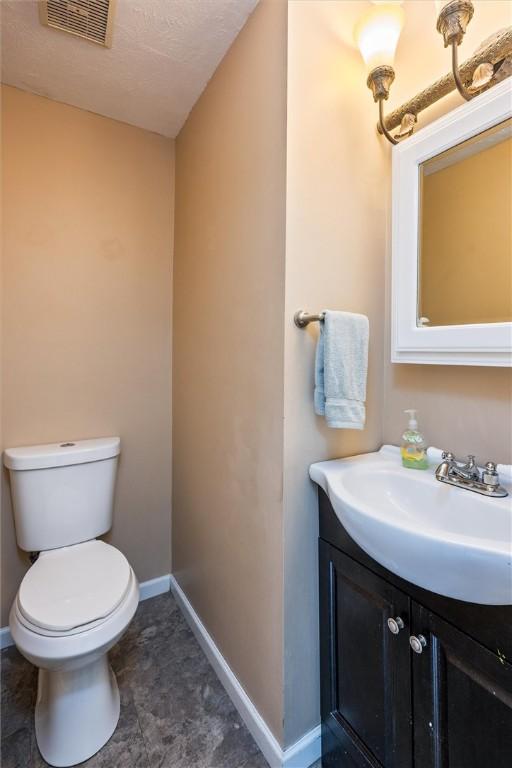 86 Leonard Rd, Greece, NY 14616 - half bath featuring vanity, baseboards, and toilet
