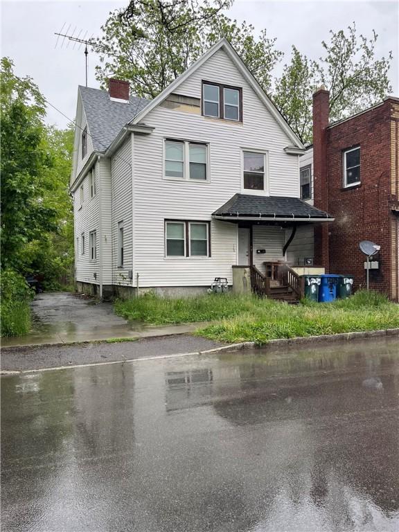 128 Otis St, Rochester, NY 14606 - view of front of house with roof with shingles and a chimney