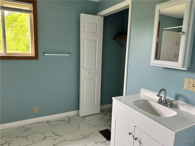 21 Church St, Fine, NY 13617 - bathroom with vanity, baseboards, and marble finish floors