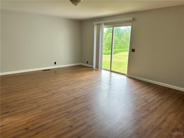 21 Church St, Fine, NY 13617 - unfurnished room featuring baseboards and dark wood-style flooring