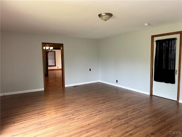 21 Church St, Fine, NY 13617 - spare room featuring a chandelier, dark wood-style flooring, baseboards, and a smoke detector