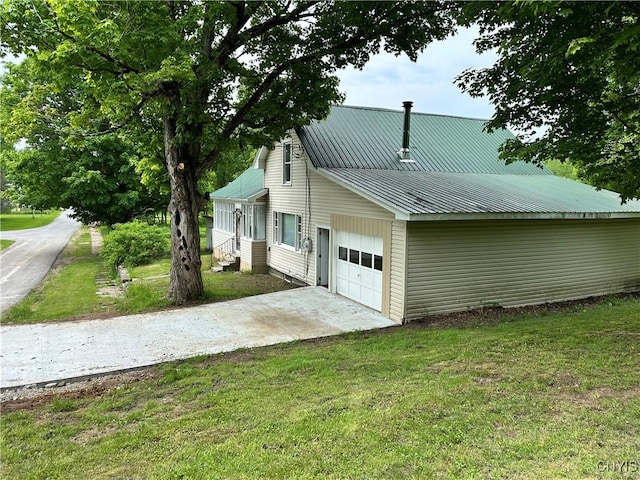21 Church St, Fine, NY 13617 - view of home's exterior with a yard, a garage, concrete driveway, and metal roof