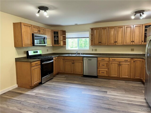 21 Church St, Fine, NY 13617 - kitchen with appliances with stainless steel finishes, open shelves, brown cabinets, and dark countertops