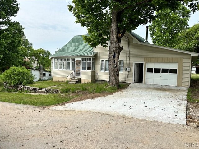 21 Church St, Fine, NY 13617 - view of front of home with entry steps, an attached garage, and driveway
