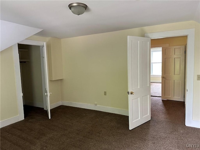 21 Church St, Fine, NY 13617 - unfurnished bedroom with dark colored carpet, baseboards, and a closet