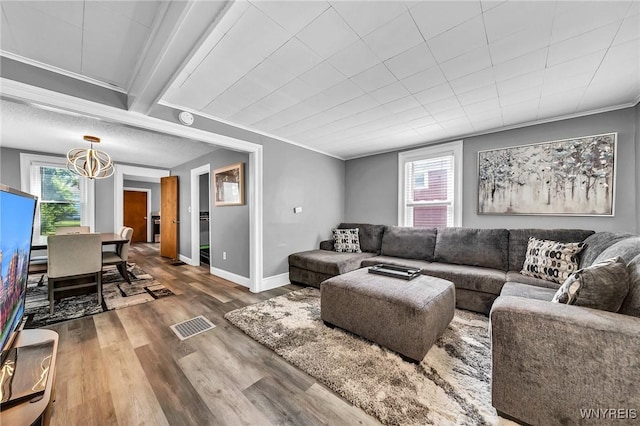 355 Bryant St, North Tonawanda, NY 14120 - living area featuring a chandelier, crown molding, wood finished floors, and baseboards