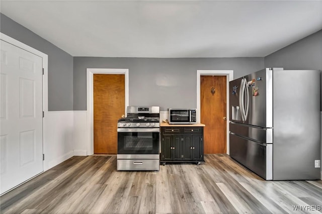 355 Bryant St, North Tonawanda, NY 14120 - kitchen with appliances with stainless steel finishes, light wood-type flooring, light countertops, and baseboards