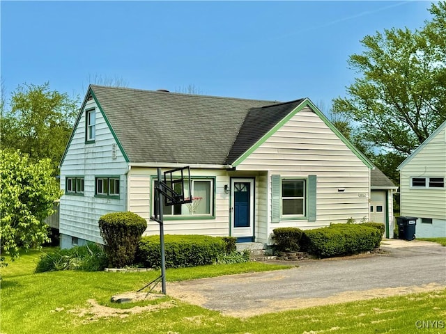 5812 S Street Rd, Fleming, NY 13021 - view of front of home with roof with shingles, a front yard, and a garage