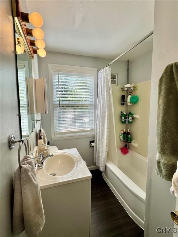 5812 S Street Rd, Fleming, NY 13021 - bathroom with vanity, wood finished floors, shower / bath combo, and baseboards