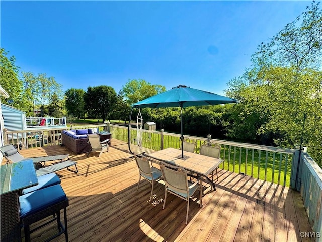 5812 S Street Rd, Fleming, NY 13021 - deck with outdoor dining space, a yard, an outdoor living space, and view of wooded area