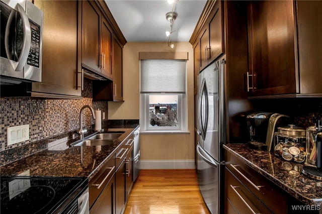 83 Bryant St Unit 7D, Buffalo, NY 14209 - kitchen featuring stainless steel appliances, a sink, baseboards, and backsplash