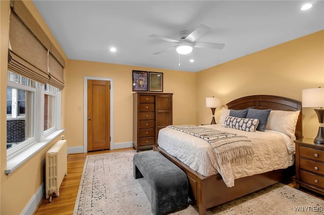 83 Bryant St Unit 7D, Buffalo, NY 14209 - bedroom with radiator, baseboards, light wood-type flooring, recessed lighting, and a ceiling fan