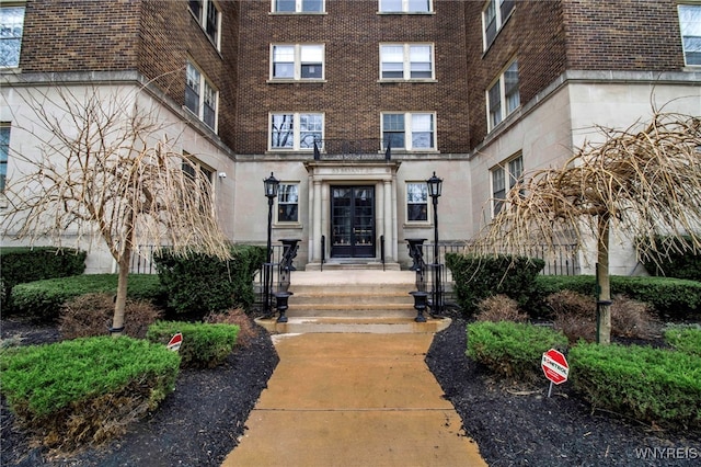 83 Bryant St Unit 7D, Buffalo, NY 14209 - view of exterior entry featuring french doors and brick siding