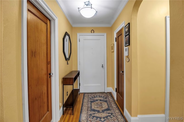 83 Bryant St Unit 7D, Buffalo, NY 14209 - doorway to outside with wood finished floors, crown molding, and arched walkways