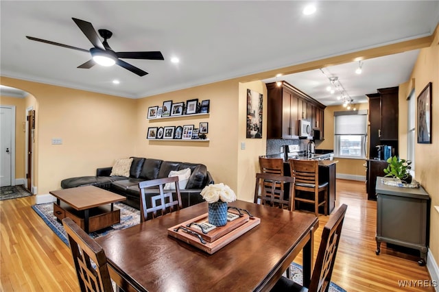 83 Bryant St Unit 7D, Buffalo, NY 14209 - dining space featuring arched walkways, a ceiling fan, light wood finished floors, baseboards, and recessed lighting