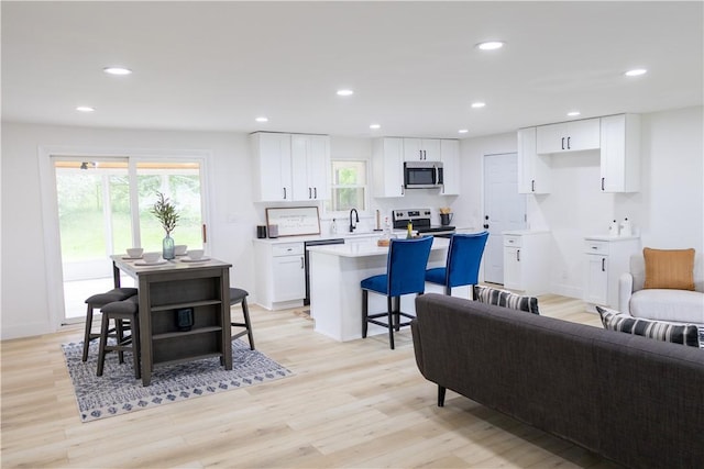 136 Nevins Rd, Henrietta, NY 14467 - living room with light wood finished floors and recessed lighting