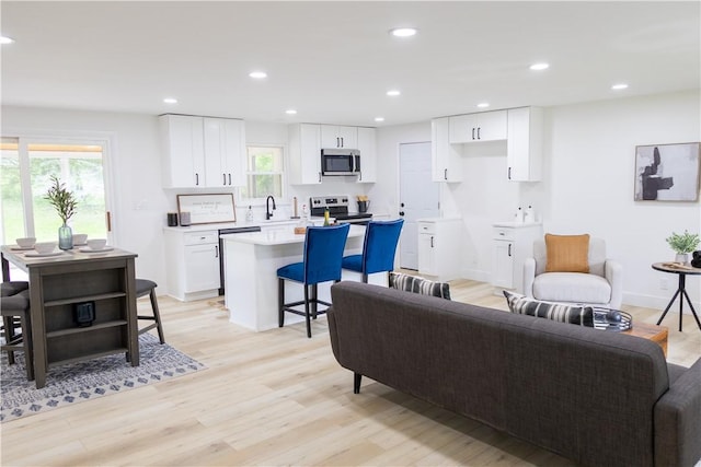 136 Nevins Rd, Henrietta, NY 14467 - living area with light wood-type flooring and recessed lighting