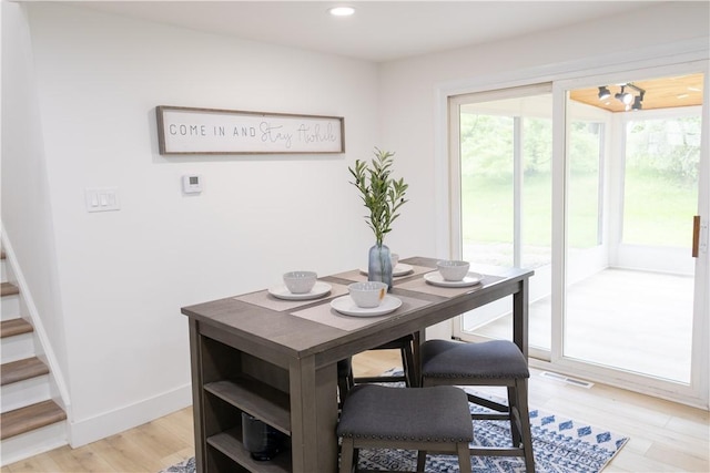136 Nevins Rd, Henrietta, NY 14467 - dining space featuring recessed lighting, stairway, light wood-style floors, and baseboards