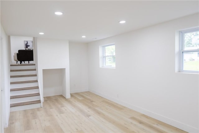 136 Nevins Rd, Henrietta, NY 14467 - below grade area with plenty of natural light, light wood-type flooring, recessed lighting, stairway, and baseboards