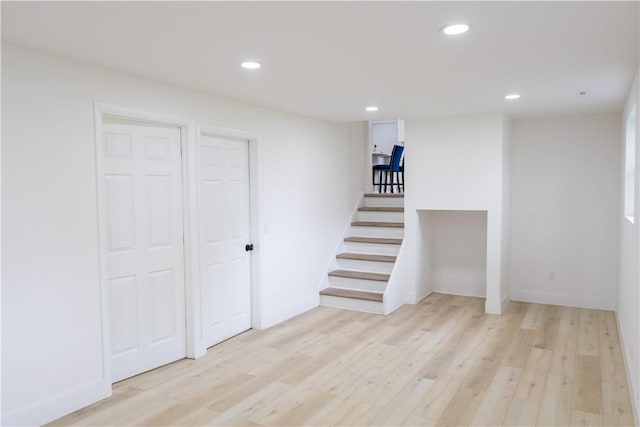 136 Nevins Rd, Henrietta, NY 14467 - finished below grade area with light wood-type flooring, recessed lighting, stairway, and baseboards