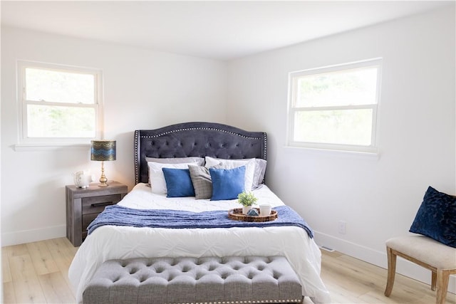 136 Nevins Rd, Henrietta, NY 14467 - bedroom featuring wood finished floors, multiple windows, and baseboards