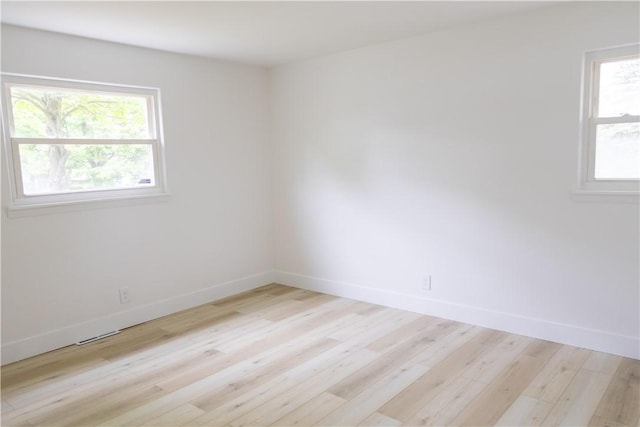 136 Nevins Rd, Henrietta, NY 14467 - empty room featuring plenty of natural light, light wood-type flooring, and baseboards
