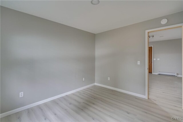 34292 State Route 26, Champion, NY 13619 - unfurnished room with light wood-type flooring, a baseboard heating unit, baseboards, and a smoke detector