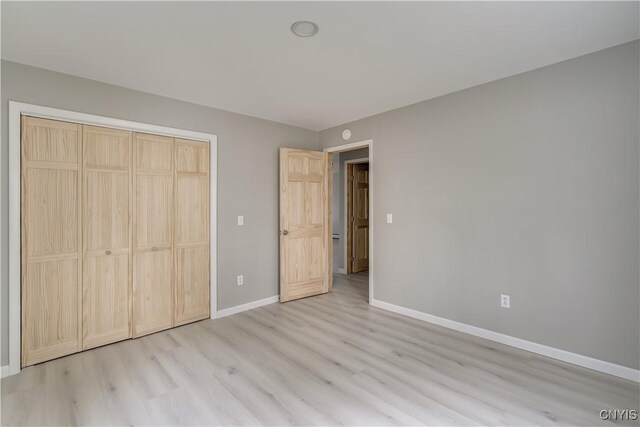 34292 State Route 26, Champion, NY 13619 - unfurnished bedroom with light wood-style flooring, baseboards, and a closet
