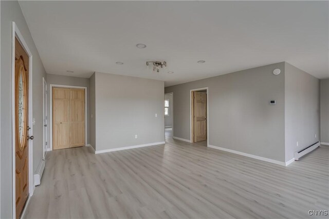 34292 State Route 26, Champion, NY 13619 - unfurnished room featuring a baseboard heating unit, light wood-style flooring, and baseboards