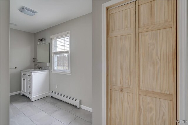 34292 State Route 26, Champion, NY 13619 - laundry area featuring a baseboard heating unit, baseboards, light tile patterned flooring, and a sink