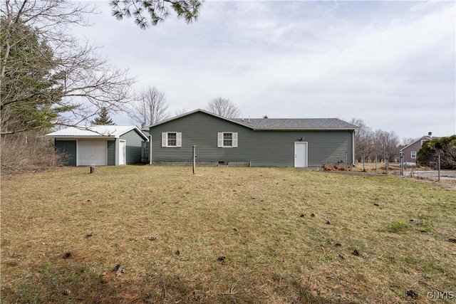 34292 State Route 26, Champion, NY 13619 - back of property featuring a lawn, a detached garage, and an outbuilding