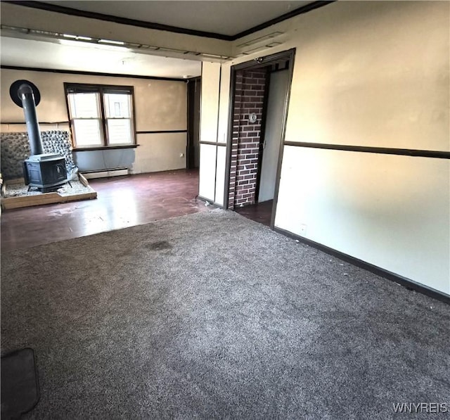 55 Awood Pl, Cheektowaga, NY 14225 - empty room featuring a wood stove and a baseboard heating unit