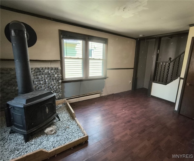 55 Awood Pl, Cheektowaga, NY 14225 - living room featuring wood finished floors, a wood stove, a baseboard heating unit, and stairs