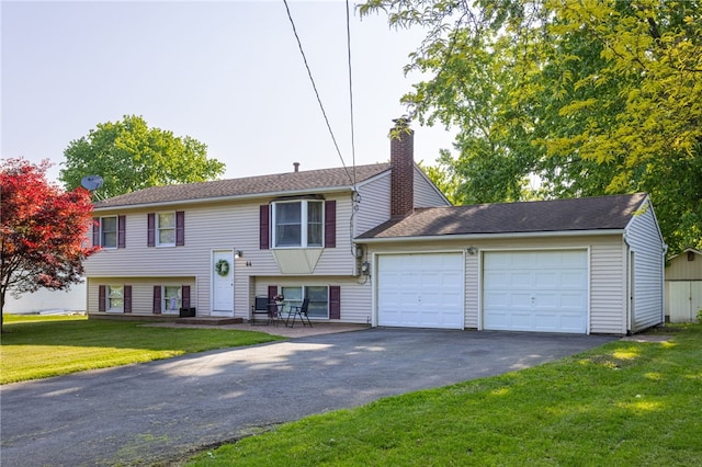 44 Hidden Creek Ln, Hamlin, NY 14464 - bi-level home featuring asphalt driveway, an attached garage, a chimney, and a front lawn