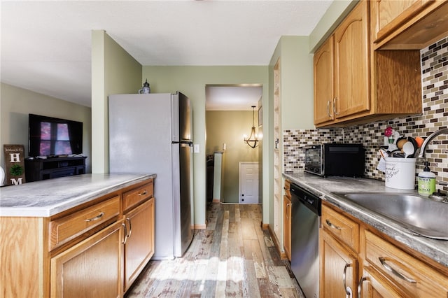 44 Hidden Creek Ln, Hamlin, NY 14464 - kitchen with dishwasher, freestanding refrigerator, light wood finished floors, a sink, and decorative backsplash