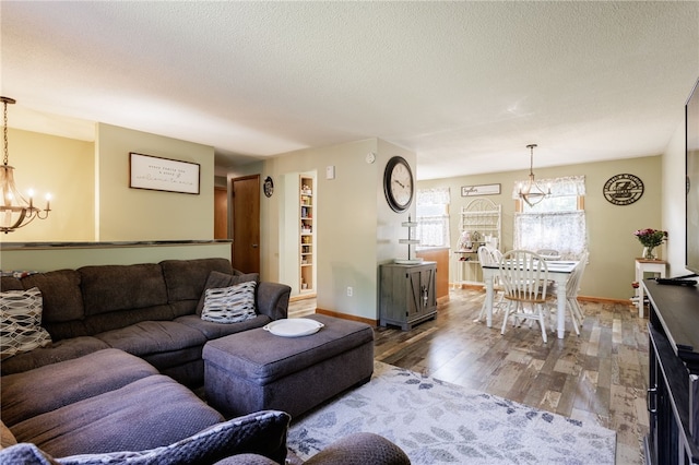 44 Hidden Creek Ln, Hamlin, NY 14464 - living area with a chandelier, wood finished floors, baseboards, and a textured ceiling