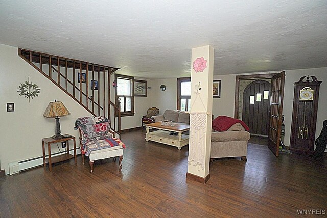 2477 Ridge Rd, Lewiston, NY 14131 - living area with a baseboard radiator, wood finished floors, stairs, baseboards, and a textured ceiling