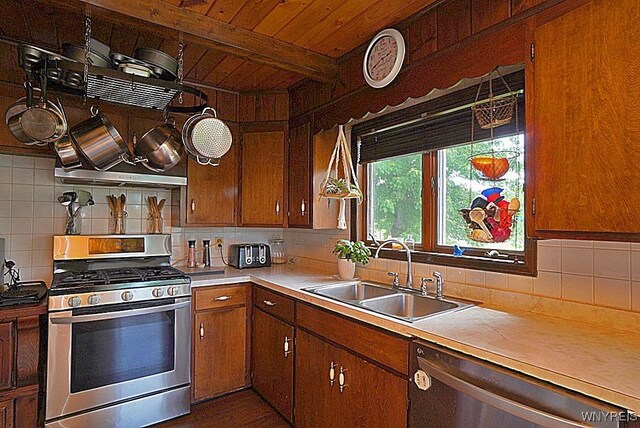 2477 Ridge Rd, Lewiston, NY 14131 - kitchen with stainless steel appliances, a sink, backsplash, light countertops, and wood ceiling with exposed beams