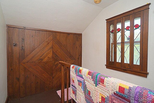 2477 Ridge Rd, Lewiston, NY 14131 - bedroom featuring vaulted ceiling and wooden walls