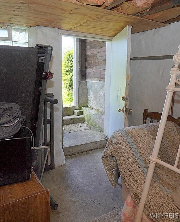 2477 Ridge Rd, Lewiston, NY 14131 - doorway with unfinished concrete floors and wood ceiling
