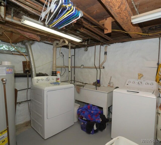 2477 Ridge Rd, Lewiston, NY 14131 - unfinished basement featuring gas water heater, independent washer and dryer, and a sink