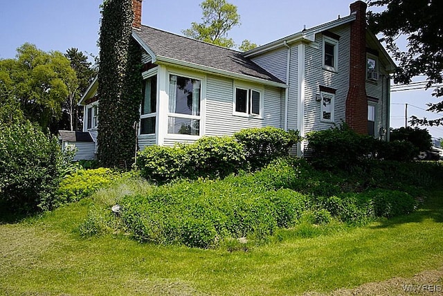 2477 Ridge Rd, Lewiston, NY 14131 - view of home's exterior featuring a chimney and a yard