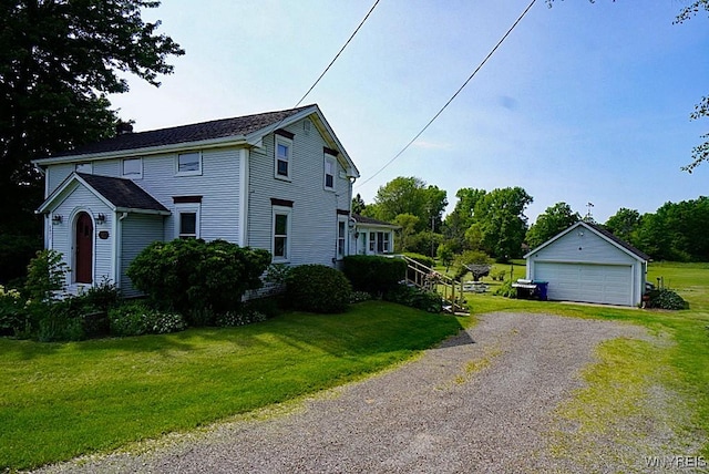 2477 Ridge Rd, Lewiston, NY 14131 - view of home's exterior with a detached garage, an outbuilding, and a yard