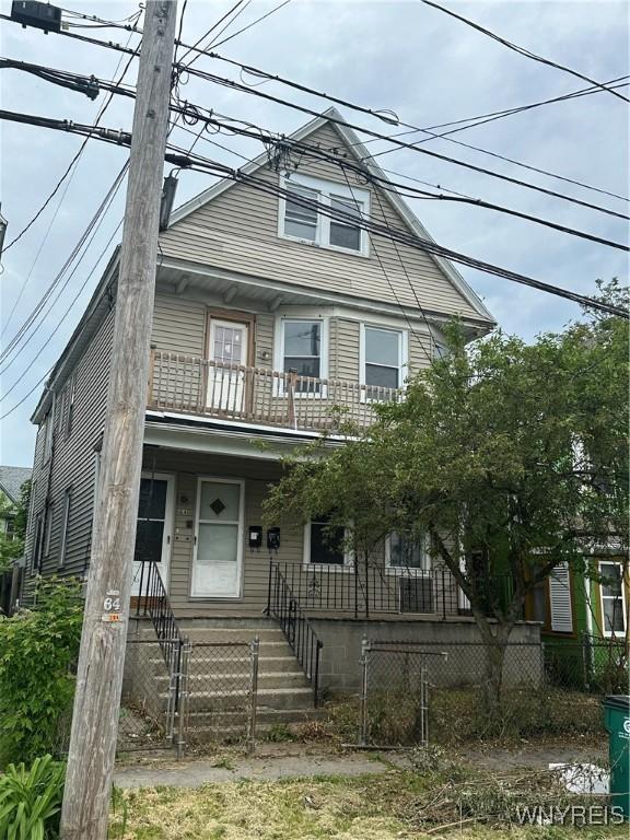 64 Barton St, Buffalo, NY 14213 - view of front of house featuring a balcony, a fenced front yard, and covered porch